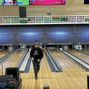 a man standing in a bowling alley