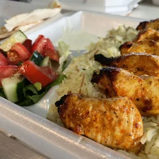 chicken, rice, and salad in a plastic container