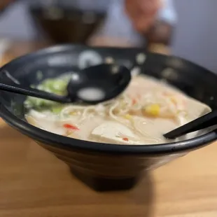 a bowl of ramen with chopsticks