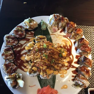 From right to left, dragon roll, tornado in middle, shrimp tempura on the left