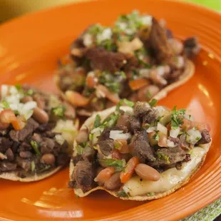 Vampiros: (Tostada - Handmade tortilla toasted, choice of meat, cheese, whole pinto beans.