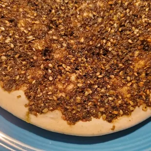 Maniesh-has no meat,but has Zaatar seasoning. Always loaded with seasoning.