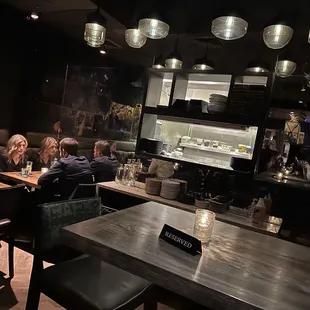 a group of people sitting at a table in a restaurant