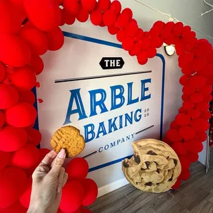 Peanut butter cookie in front of Arble's Valentine display