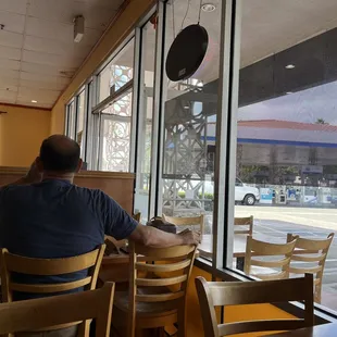 a man sitting at a table in a restaurant