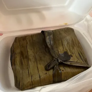 a banana leaf in a styrofoam container