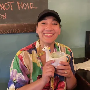Bar seating and woman holding drink