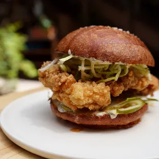 Fried-Chicken Sandwich with hot honey, herb-buttermilk mayo, shredduce, pickle, house-made brioche bun