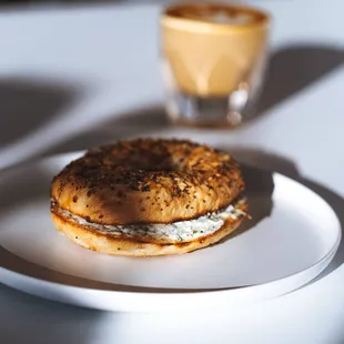A schmear'd bagel with a cortado