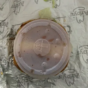 Size of Wagyu burger compared to regular sized drink lid.  Burger is under there