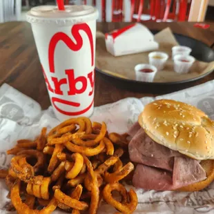 a hamburger, fries, and a drink