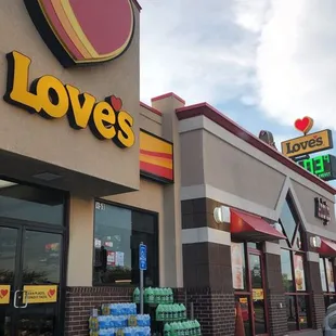 a man standing in front of a love's restaurant