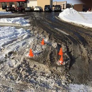 orange cones on a snowy road