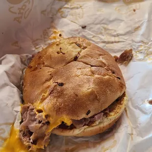 a half eaten sandwich on a wrapper