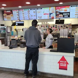 a man ordering food at a fast food restaurant