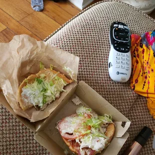 a sandwich and a cell phone on a table
