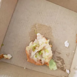 a half eaten sandwich in a box