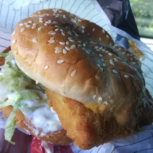 a chicken sandwich with lettuce and cheese