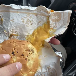 Sandwich with hole in wrapper as well as cheese not on the sandwich all of it on the wrapper