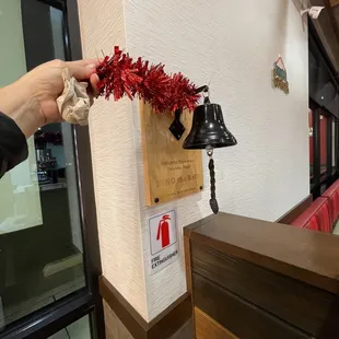 a hand reaching for a bell