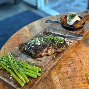 RIBEYE-24 oZ. prime. dry-aged. W/ DUCK FAT POTATOES hungarian paprika, créme, ROASTED ASPARAGUS lemon, parmesan, herbs