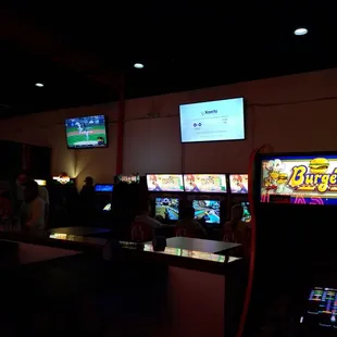 people playing video games in a dark room