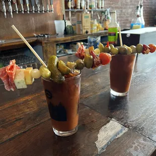 two bloody cocktails on a bar