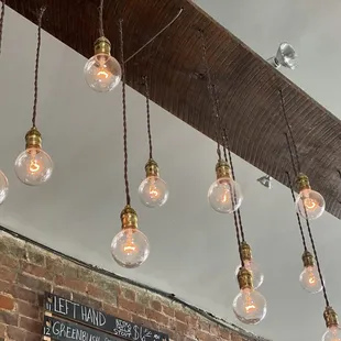 a bunch of light bulbs hanging from the ceiling