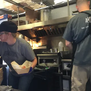 a woman preparing food in a kitchen