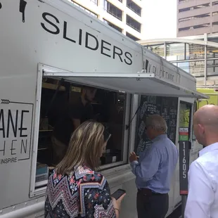 people ordering food from a food truck