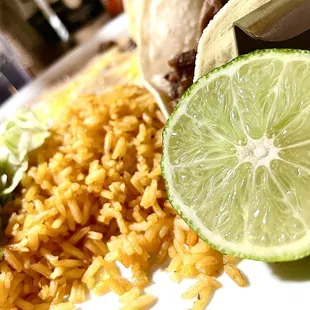 Lime, guacamole, rice, carne asada tacos