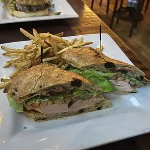 Tavern club with truffle fries, arch city burger in the background