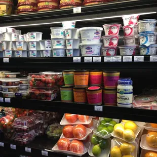 a shelf of yogurt and fruit