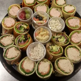 a platter of sandwiches and dips