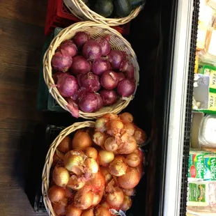 baskets of onions and avocados