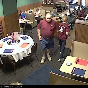 a man and a woman walking through a restaurant