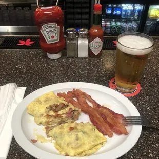 3 egg omelette with Swiss cheese, ham, mushrooms and tomatoes with a side of perfectly cooked bacon.