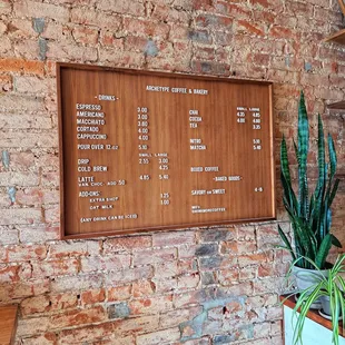 a menu on a brick wall