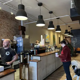 a man and a dog in a coffee shop