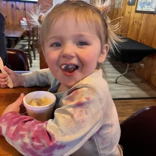 a little girl eating ice cream