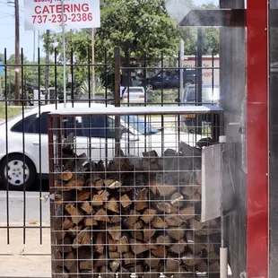 firewood stacked in a cage