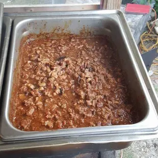 two pans of chili on a stove