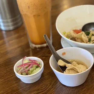 two bowls of soup and a drink