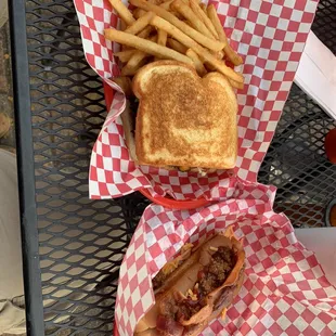 a grilled sandwich and fries