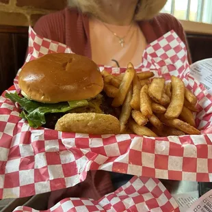 My Burger with cheddar cheese, lettuce, tomato, onion, pickles, mayo, a fried green tomato on the side and a side of crispy fries.