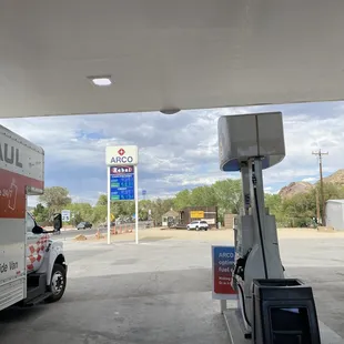 a gas station with a truck and a gas pump