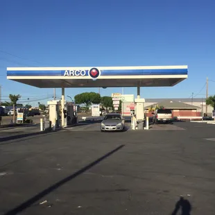 a gas station with a car parked in front of it
