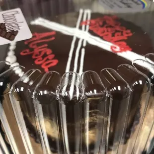 a chocolate cake in a plastic container