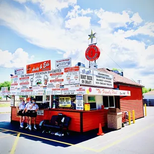 two people standing in front of a food truck