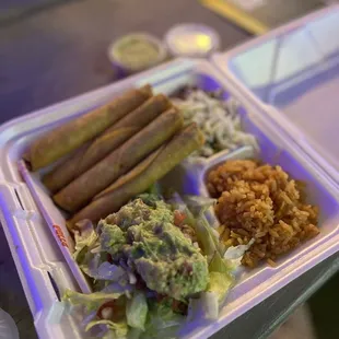Chicken flautas with beans and rice.